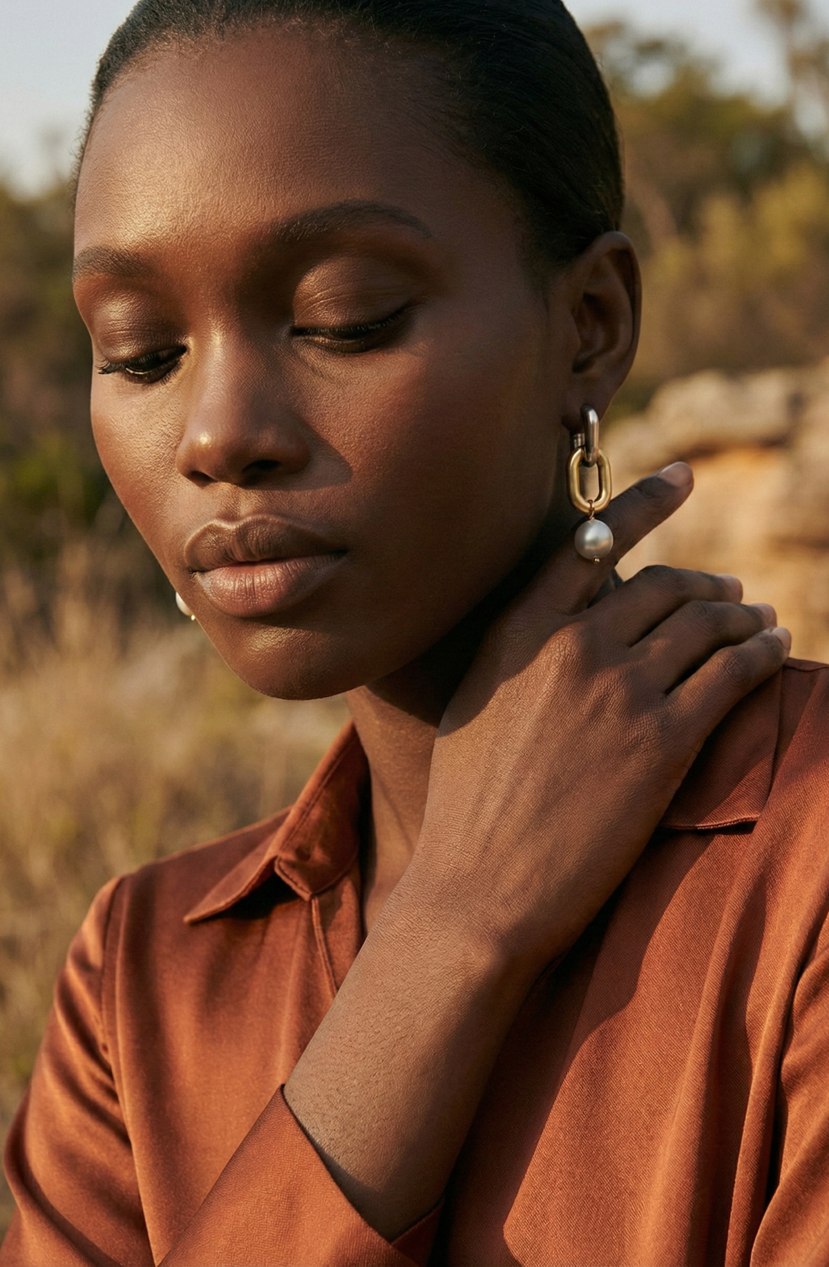 model wearing pearl earrings on a paris balcony