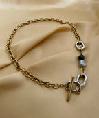 mixed-metal gold chain necklace with grey and black baroque pearls
