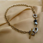 mixed-metal gold chain necklace with grey and black baroque pearls
