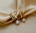 Bella earrings featuring a petite 1.5cm gold linear drop with a dangling 8mm white baroque freshwater pearl. Minimalist 18k gold plated stainless steel jewelry