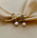 Close-up detail of AAA quality white baroque pearl on Bella earrings. High-lustre organic pearl texture paired with 18k gold plated hardware