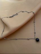 Necklace with a black pearl on a silver beaded chain