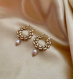 Close-up detail of AAA quality oval champagne freshwater pearl attached to PVD 18k gold plated stainless steel hardware. High-lustre pearl jewelry texture