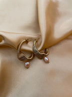 Gold hoop earrings with pink pearl drops
