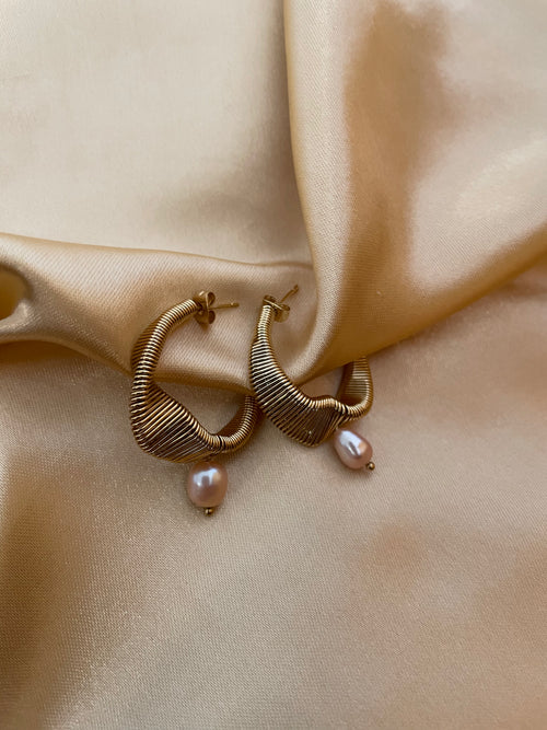 Gold hoop earrings with pink pearl drops