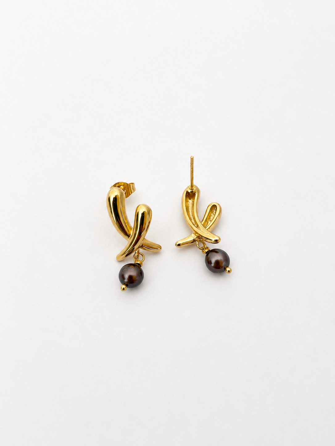 Back and angled view of gold cross stud earrings with dark baroque freshwater pearl drops and stud posts