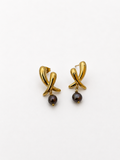 Pair of sculptural gold cross stud earrings with 6 mm dark baroque freshwater pearl drops.