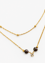Gold layered beaded necklace with two dark freshwater pearls and a sparkling cubic zirconia pendant