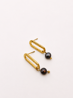 Pair of textured gold stud earrings with 6 mm dark round freshwater pearl drops.