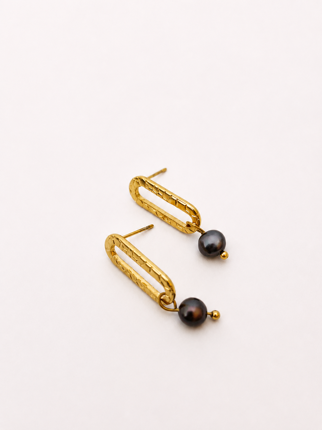 Pair of textured gold stud earrings with 6 mm dark round freshwater pearl drops.