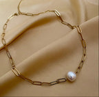 gold paperclip chain necklace featuring a single white baroque pearl pendant