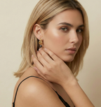 Jewelry inspiration: Stunning gold twist earrings with black pearls. Elegant styling ideas for evening wear featuring a chic updo and black cami