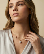 Gold baroque pearl necklace on model. Dainty gold chain jewelry with iridescent white pearls and organic shapes