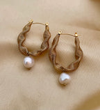 Pair of gold hoop earrings with pearl drops 