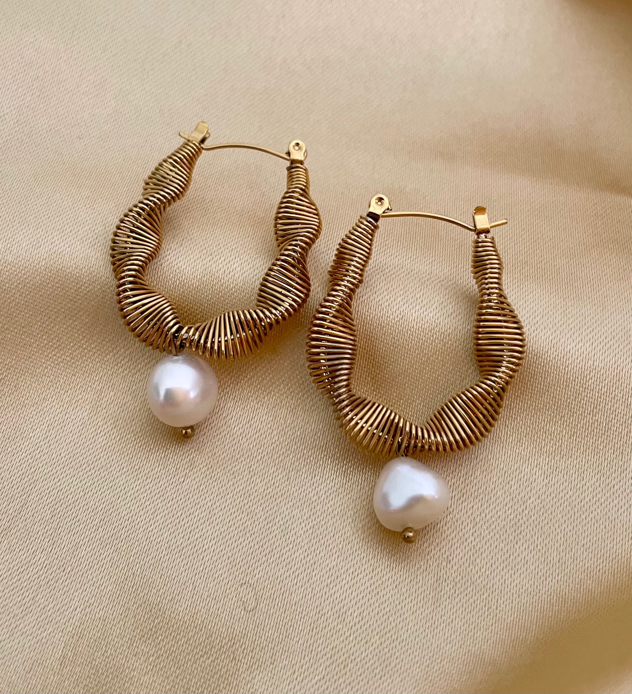 Pair of gold hoop earrings with pearl drops 