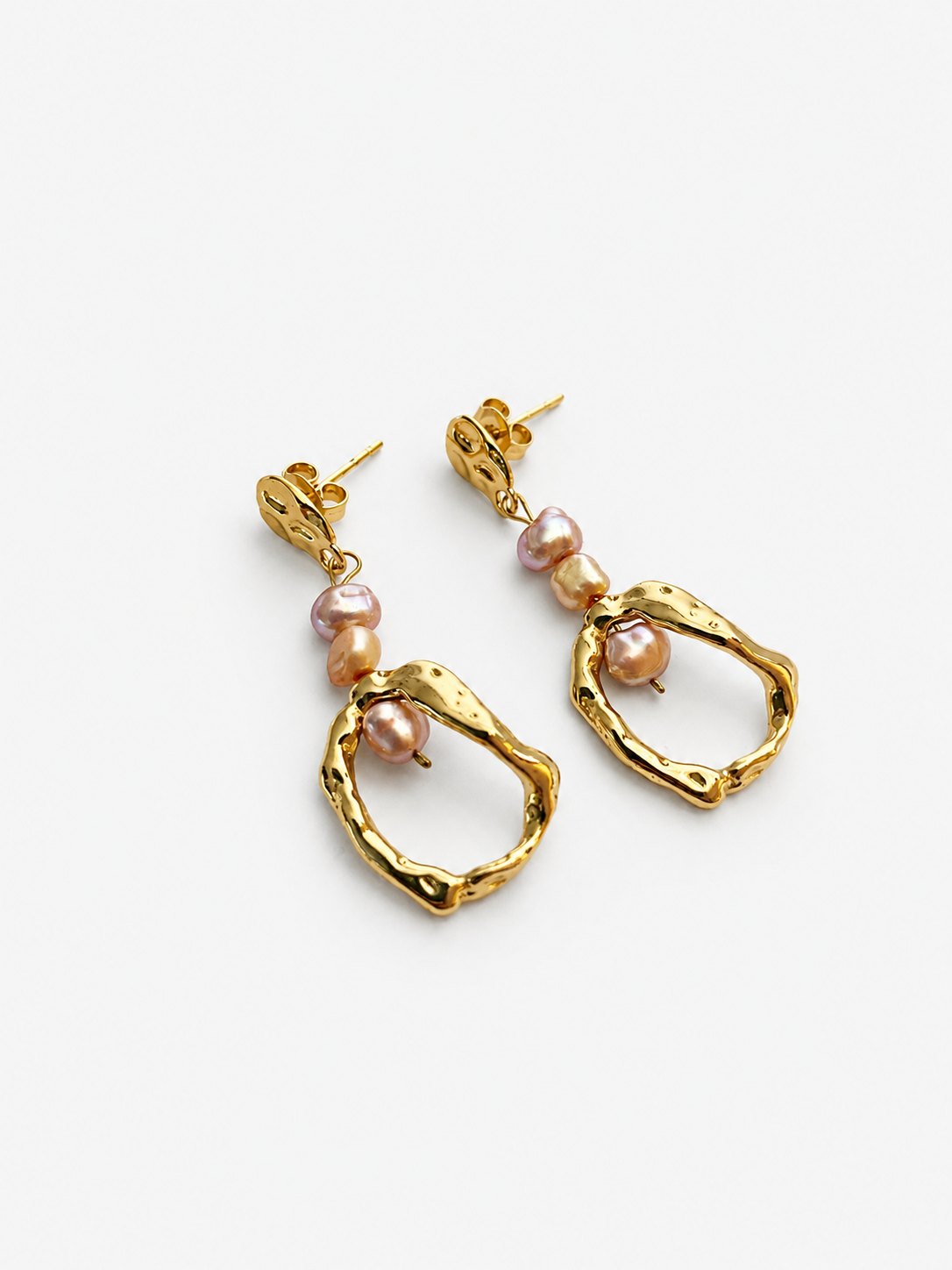 Angled pair of sculptural gold droplet earrings with 4 mm gold and pink baroque freshwater pearls.