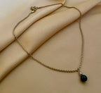 dainty gold rope chain necklace with a black and grey pearl pendant