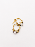 Angled view of gold creole earrings with grey baroque and Keshi freshwater pearls and polished gold beads