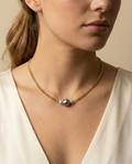 Gold chain necklace featuring a single grey baroque pearl with metallic luster, flanked by two small grey baroque pearls