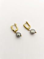 Pair of gold drop earrings with 10 mm grey baroque freshwater pearl pendants.