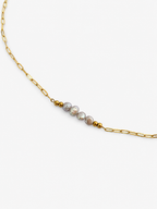 Gold elongated-link necklace with four grey baroque freshwater pearls framed by polished gold beads