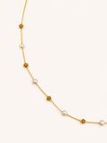 Gold station necklace with 4 mm grey baroque freshwater pearls alternating with sculpted rose details