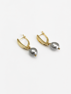 Pair of gold pandan leaf drop earrings with 10 mm grey baroque freshwater pearls.
