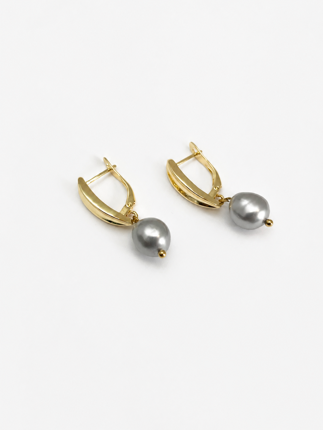 Pair of gold pandan leaf drop earrings with 10 mm grey baroque freshwater pearls.