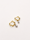 Pair of wave-inspired gold creole hoop earrings with 4 mm grey baroque freshwater pearl drops.