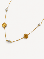 Gold Clover Bloom necklace with grey oval freshwater pearls and sculpted four-leaf clover stations
