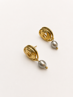 Pair of sculptural gold spiral stud earrings with 6 mm oval grey freshwater pearl drops.