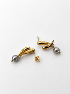 Back and angled view of gold cross stud earrings with grey freshwater pearl drops and stud posts