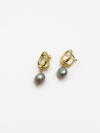 Angled pair of gold pebble drop earrings with organic grey baroque freshwater pearl drops
