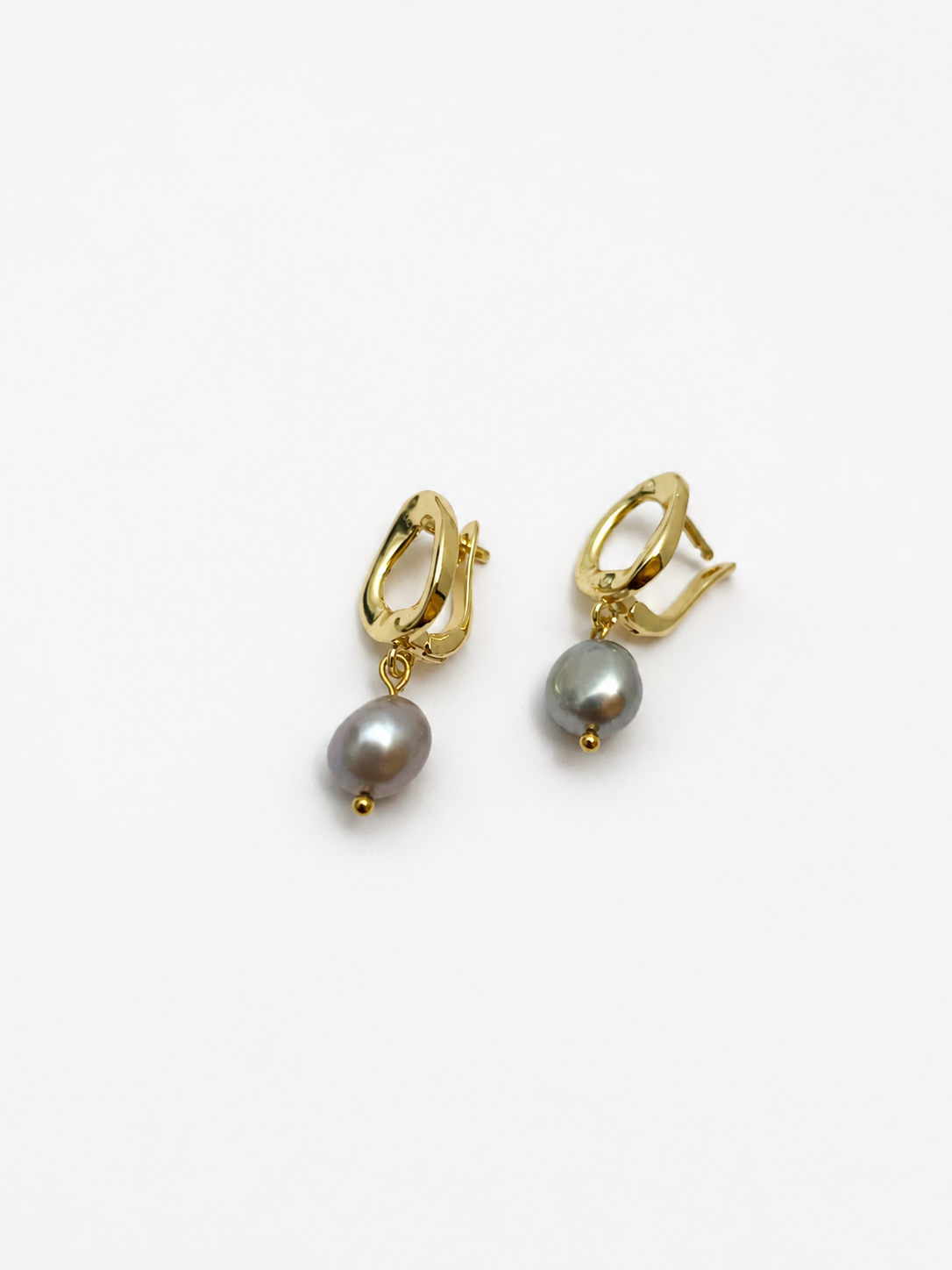 Angled pair of gold pebble drop earrings with organic grey baroque freshwater pearl drops