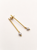 Pair of minimalist gold linear drop earrings with 4 mm round grey freshwater pearl drops.