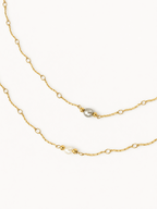 Grey and white freshwater pearl Waves necklaces with textured gold chains and polished gold bead accents