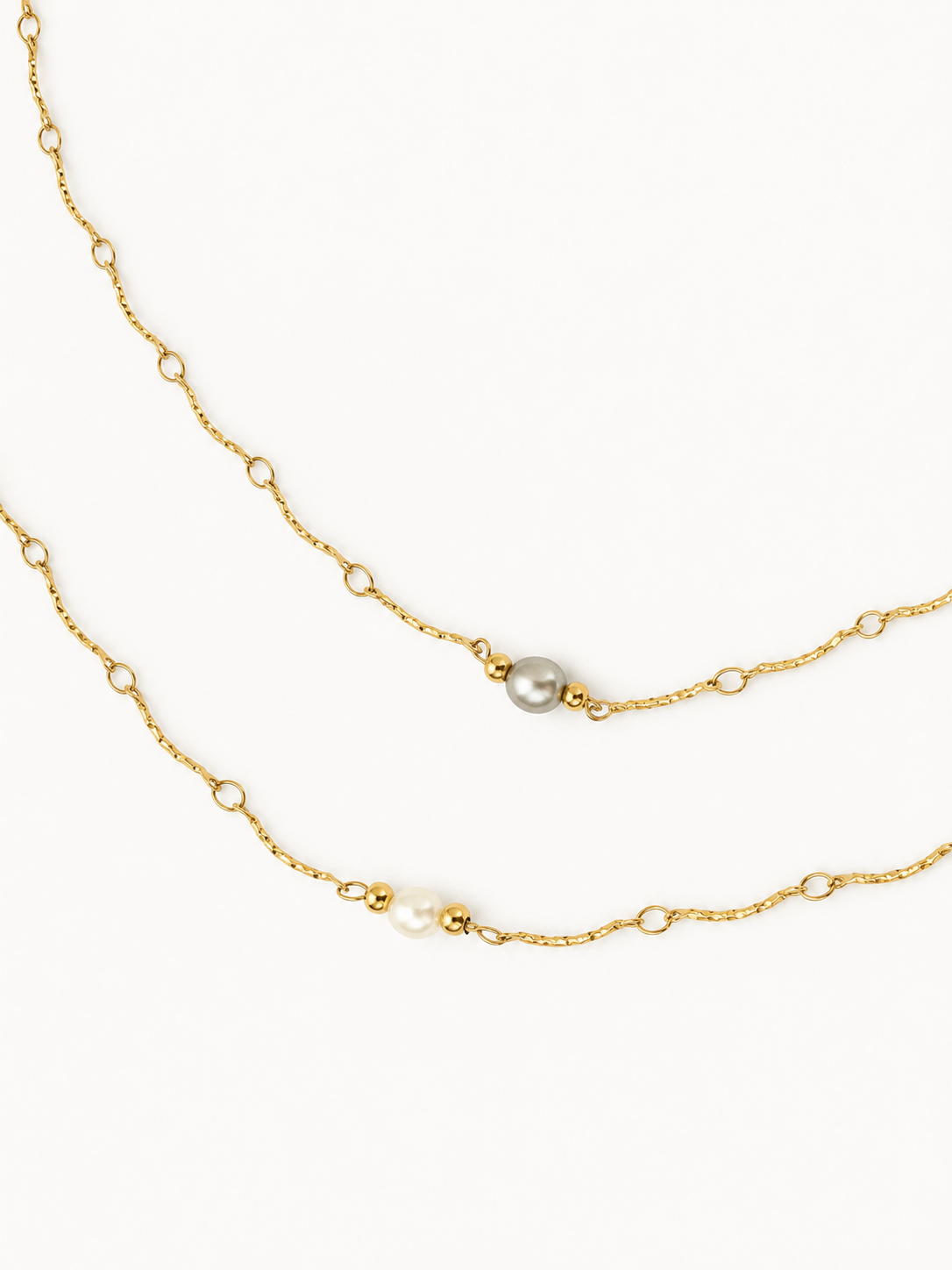 Grey and white freshwater pearl Waves necklaces with textured gold chains and polished gold bead accents