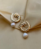 Miranda earrings featuring a textured 2.5cm gold croissant hoop with a dangling 1cm white baroque freshwater pearl. Modern 18k gold plated stainless steel jewelry