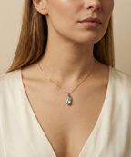 Organic grey baroque pearl necklace featuring a high-luster Keshi pearl suspended on a fine gold chain. Minimalist jewelry styling