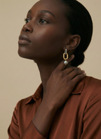 High-resolution jewelry photography showing the texture and luster of modern grey pearl earrings