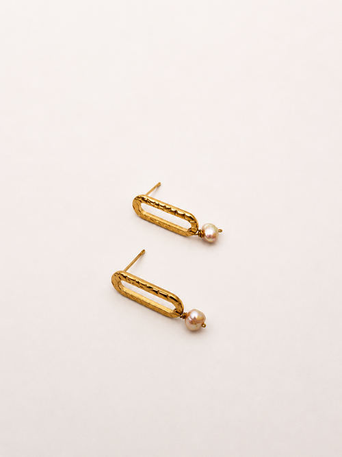 Pair of minimalist gold stud earrings with 5 mm natural pink oval freshwater pearl drops.