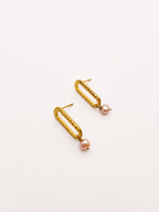 Angled pair of gold stud earrings with 5 mm natural pink oval freshwater pearl drops.