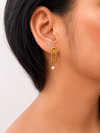 Close-up of a minimalist gold stud earring with a 5 mm natural pink freshwater pearl worn on the ear