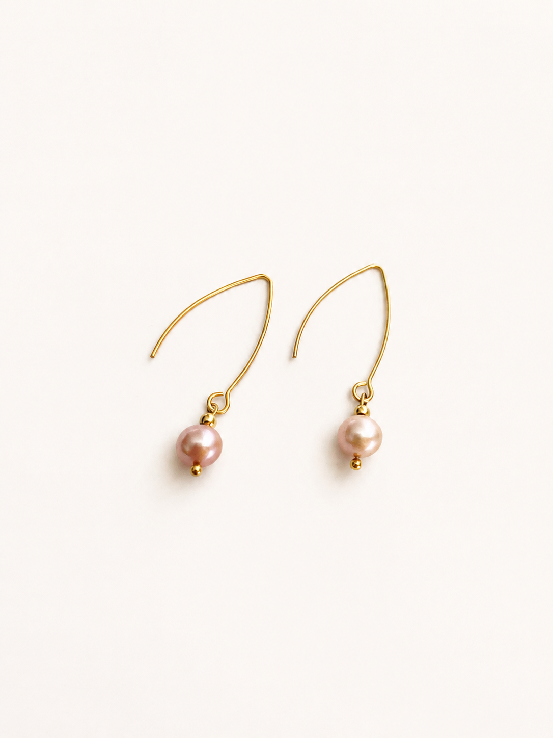 Pair of gold drop earrings with 8 mm natural pink round freshwater pearl pendants