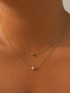 Close-up of a gold double-layer necklace with a 4 mm pink freshwater pearl worn on the neck.