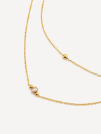 Gold double-layer necklace with a 4 mm pink freshwater pearl and polished gold bead accents