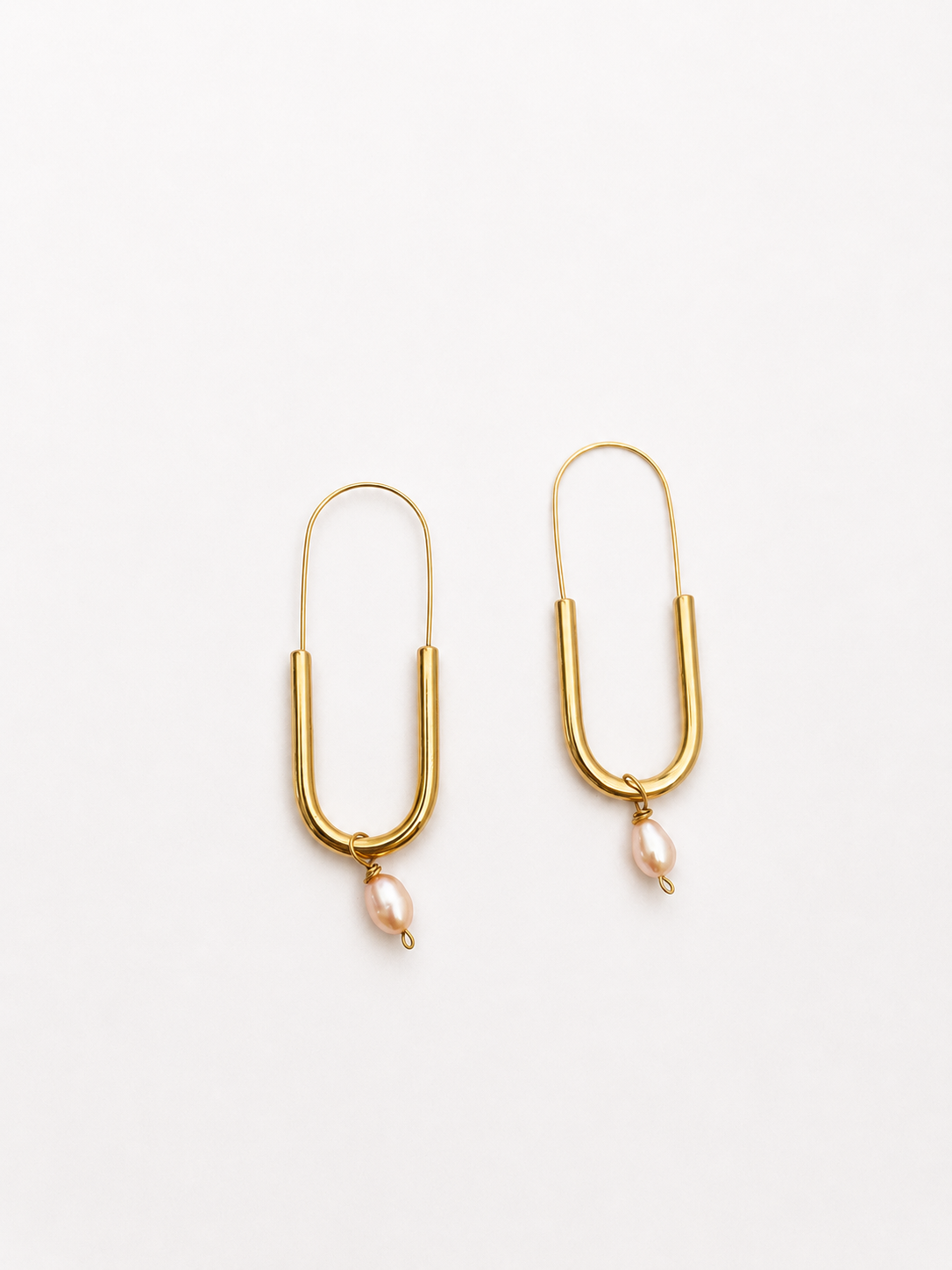 Pair of gold paperlink drop earrings with 6 mm oval pink freshwater pearl pendants.