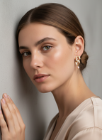 Woman wearing gold and diamond earrings with pink freshwater pearls