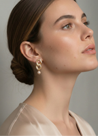 Woman wearing gold and diamond earrings with pink freshwater pearls