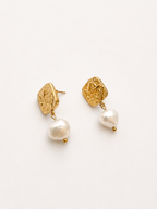 Angled pair of textured gold square stud earrings with organic white baroque freshwater pearls